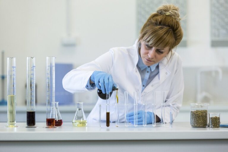 scientist pouring chemicals