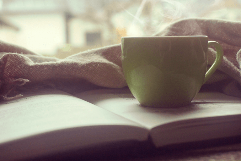 Reading a book while enjoying a coffee