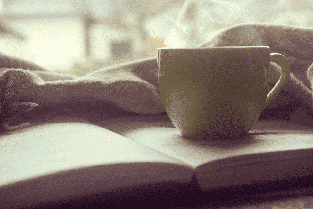 Reading a book while enjoying a coffee