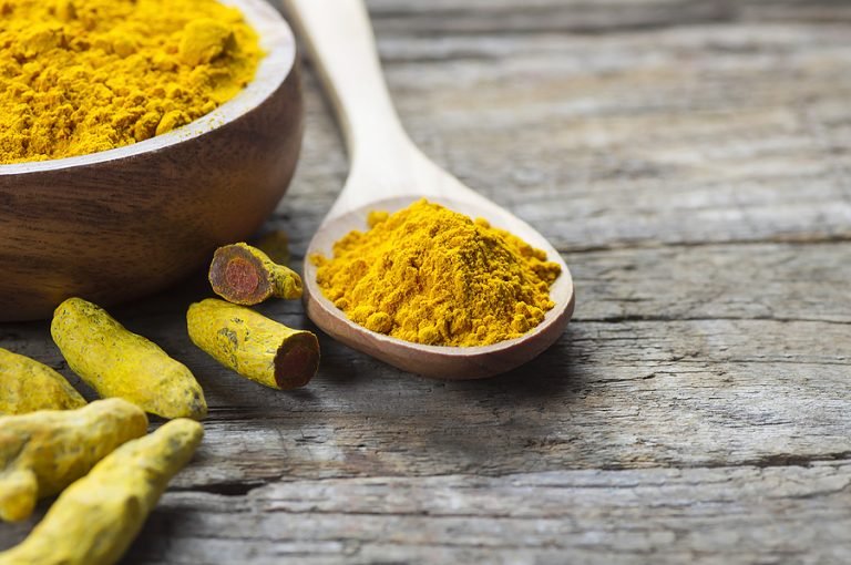 Mortar and spoon full of tumeric