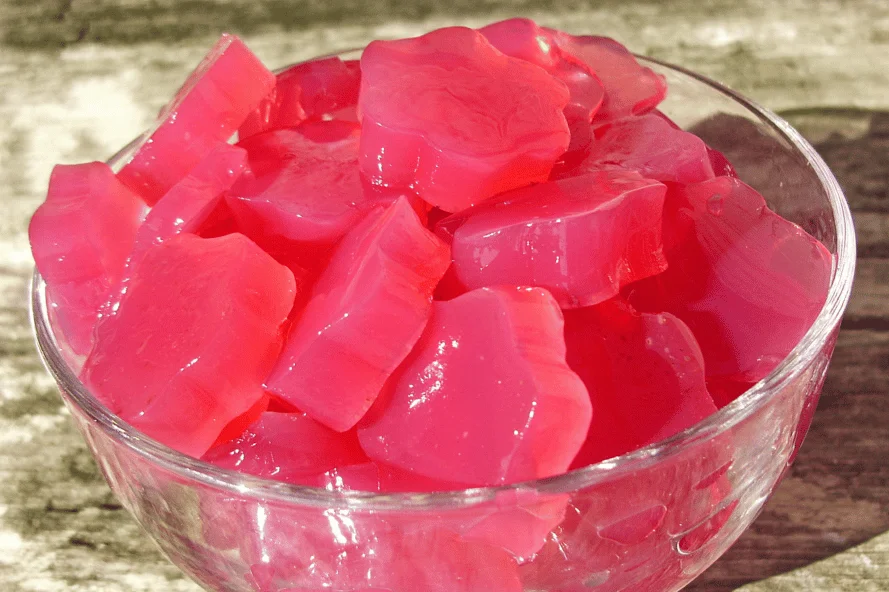 Colorful pink jelly cubes in bowl