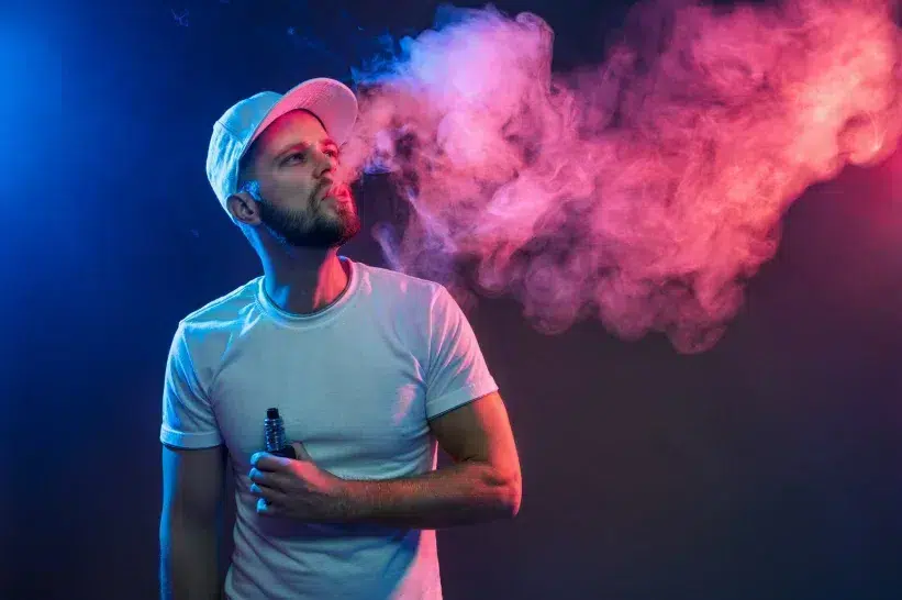 A guy in a hat vaping
