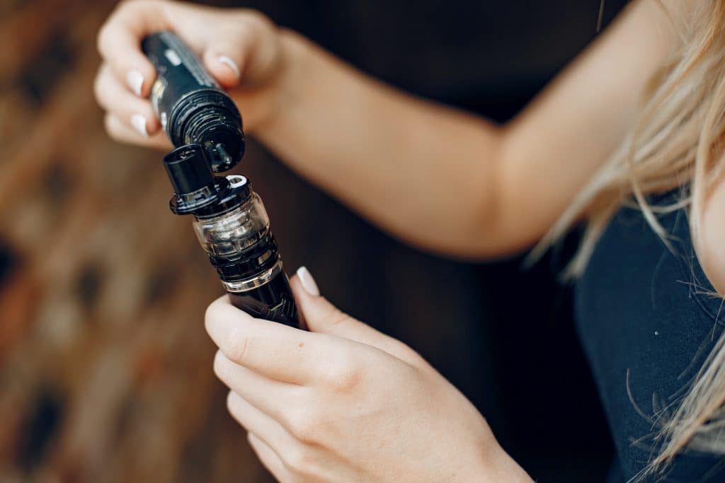 stylish young girl city with vape
