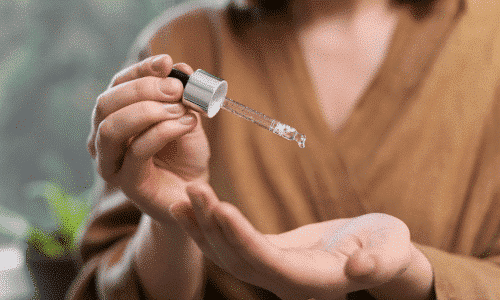 Woman holding a glass dropper