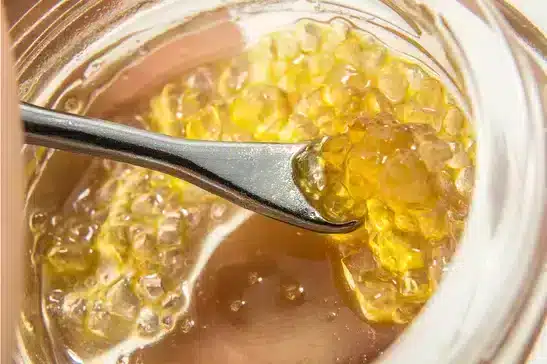 THCA diamonds scooped by a small spoon in a vial