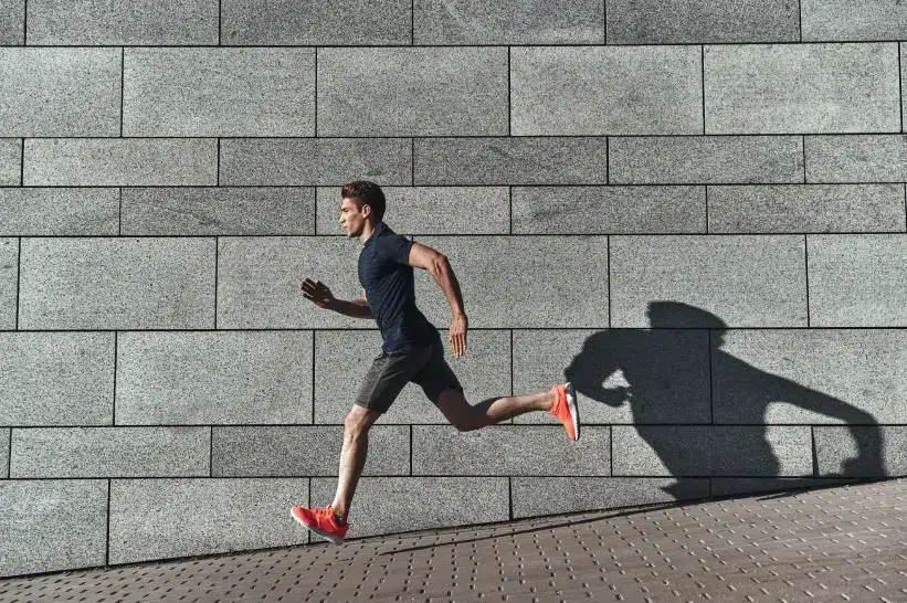 a man running on a sidewalk