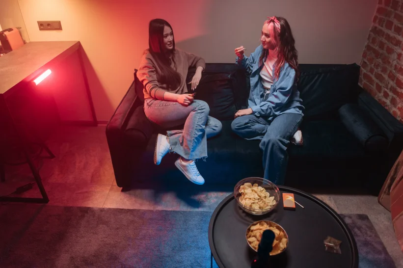 two women sitting on a couch enjoying and indica joint
