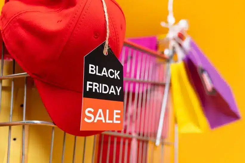 a red hat with a black tag on a wire
