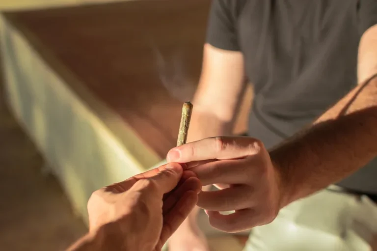 a person holding a marijuana joint