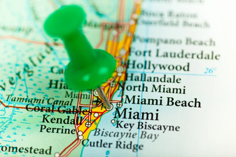 a map with a green push pin on Miami, Florida