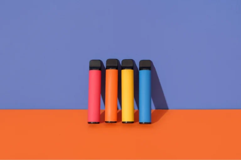 Four different colored-vapes on a wall.
