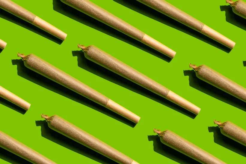 a group of cannabis joints on a green background