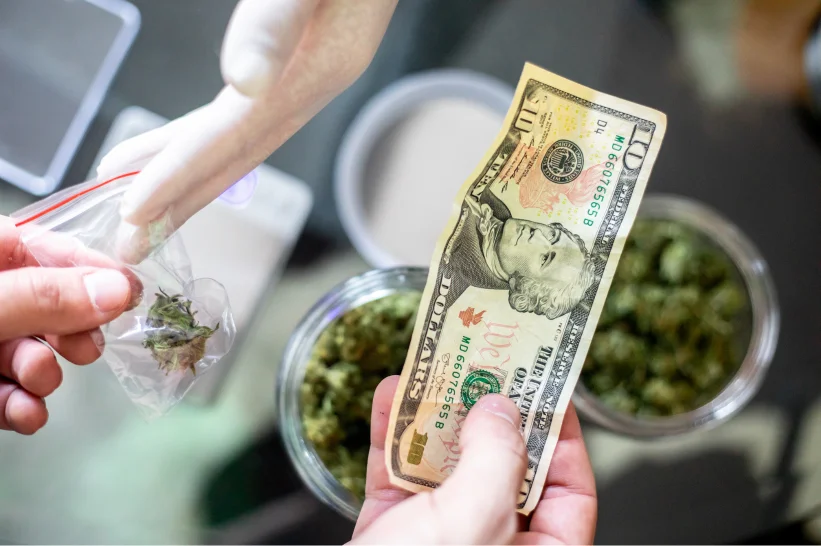 a hand holding a dollar bill