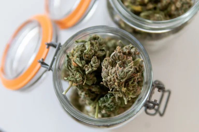 a group of THCA flower in a glass jar