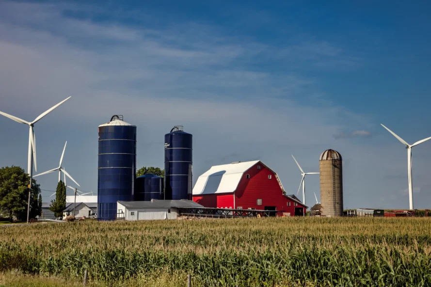 a farm with silos and windmills in Iowa, a backdrop for the Is delta 9 legal in Iowa blog