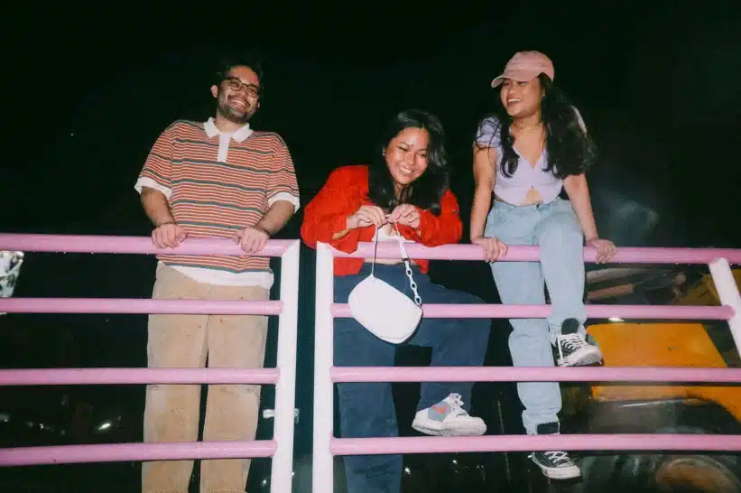 a group of gen z sitting on a railing