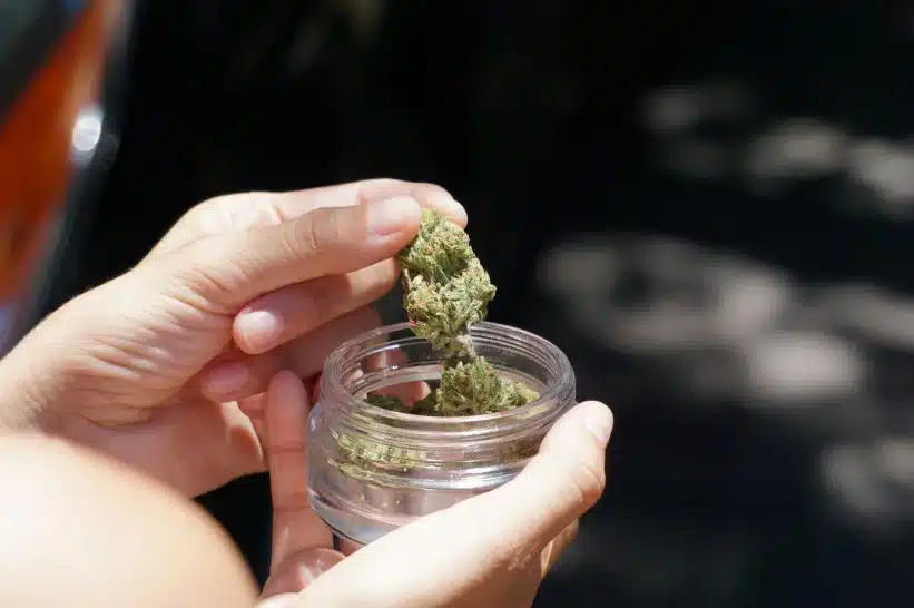 a person holding a zaza in a jar