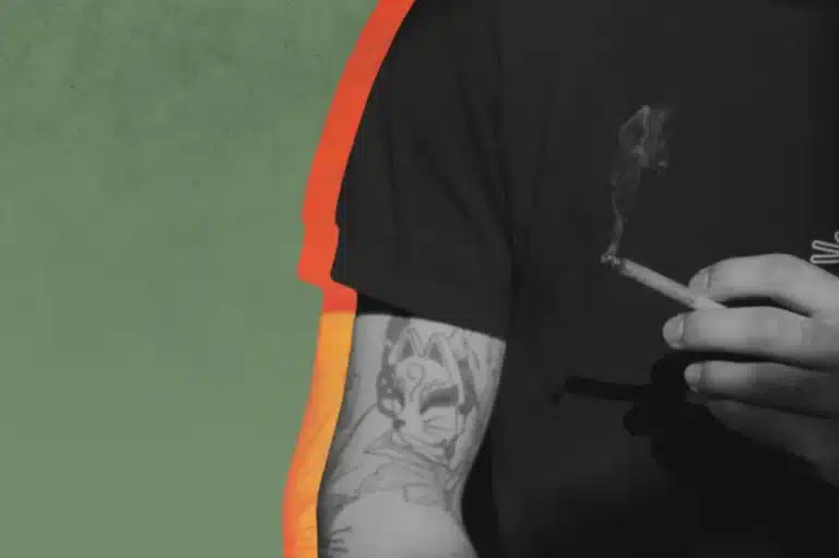 a person holding a THCA flower pre roll