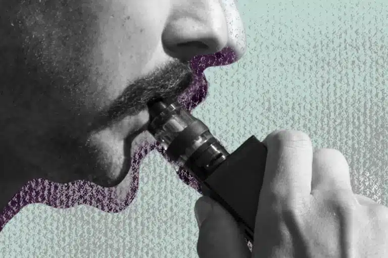 a close-up of a man vaping