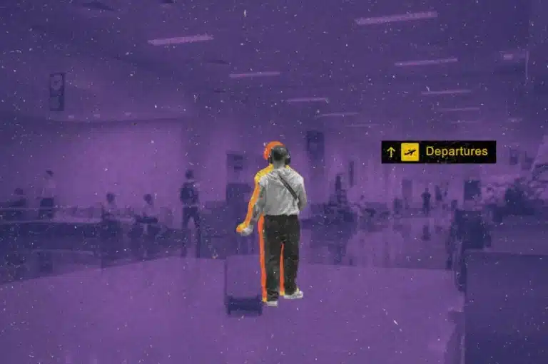A man carrying his suitcase through the airport