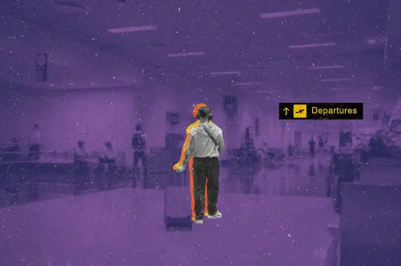 A man carrying his suitcase through the airport