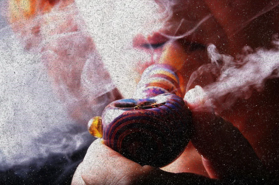 Person smoking from colorful glass hash pipe