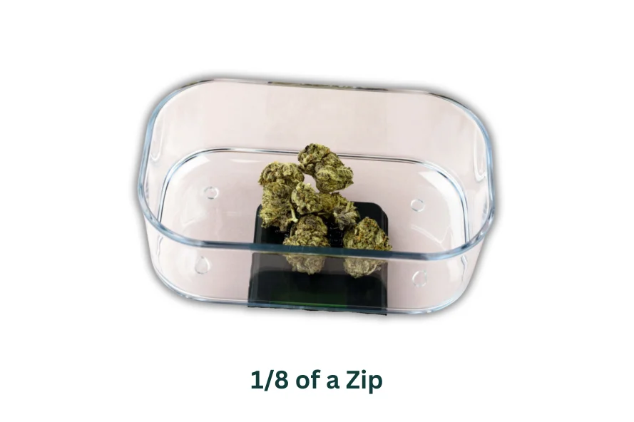 Container with 1/8 zip of cannabis buds inside