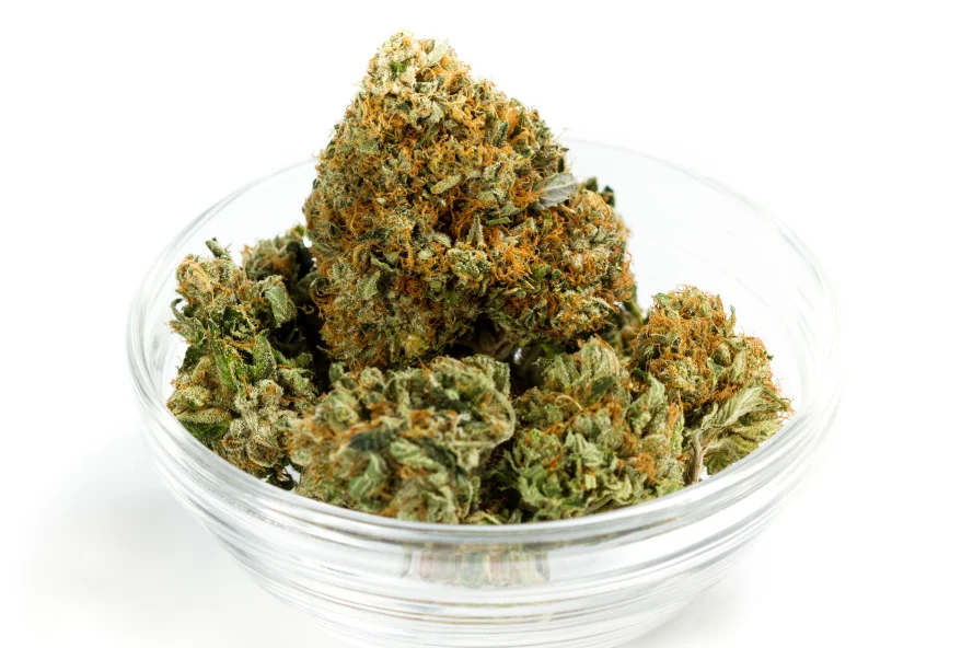 Glass bowl with dime bag of weed-worth cannabis buds