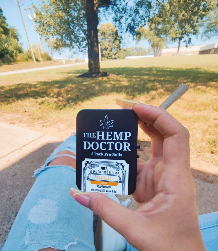 Hand holding pre-rolls in park