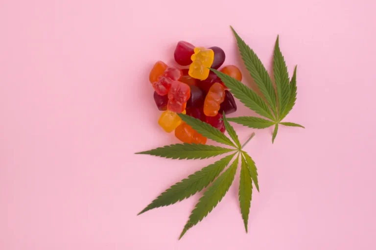 Colorful gummies and cannabis leaves